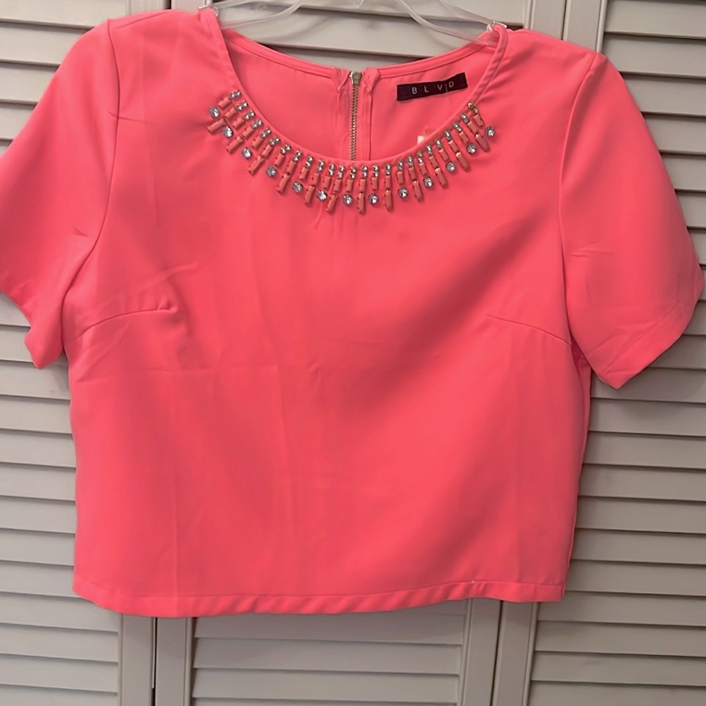 Fuchsia, pink crop top brand new with tags has a little tear in the middle.